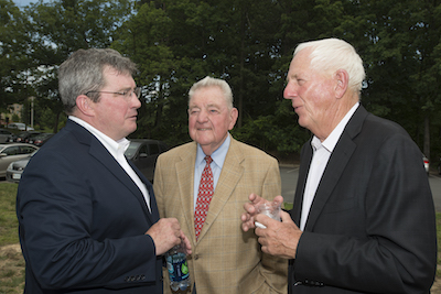 three men in suits outside